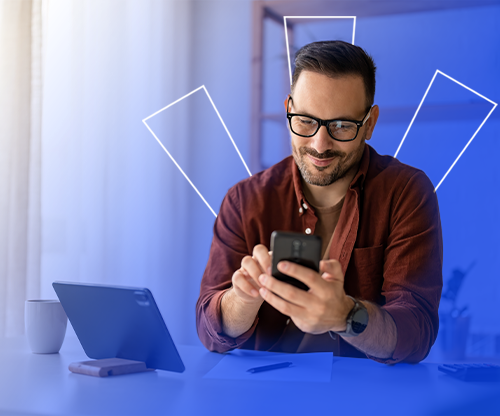 Man using phone and laptop